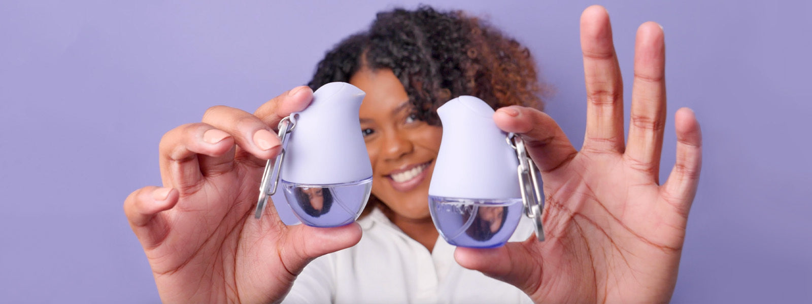 OLIKA Say Hello to Hydrated Hands, Model Holding Lavender Travel Clip On